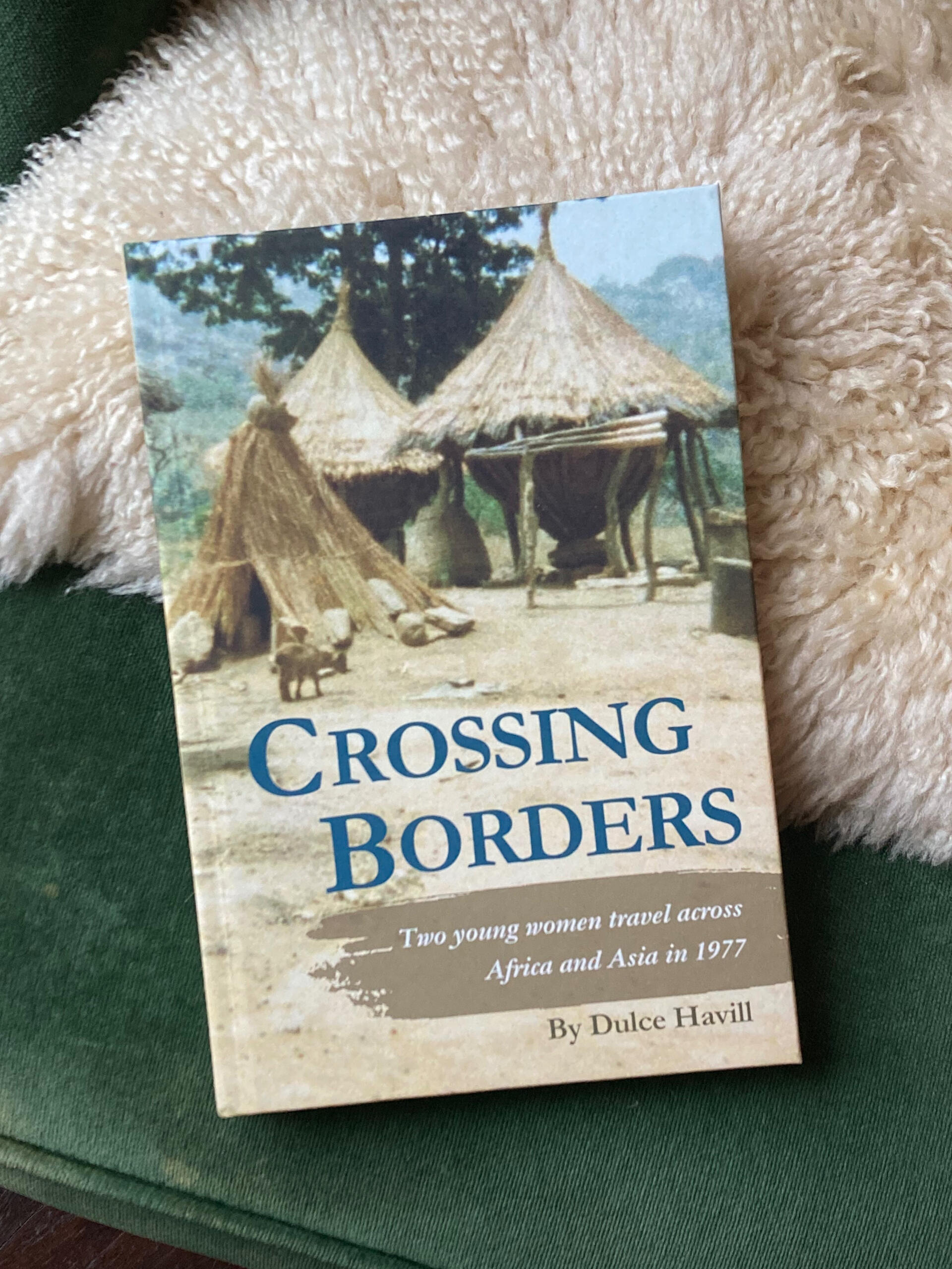 Photo of the Crossing Borders hardcover book on a chair.